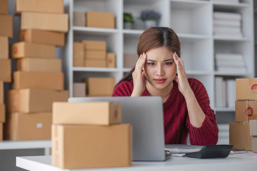 Leasing staff overwhelmed by piles of packages and manual tracking, highlighting the need to automate package management in multifamily buildings, especially during peak seasons