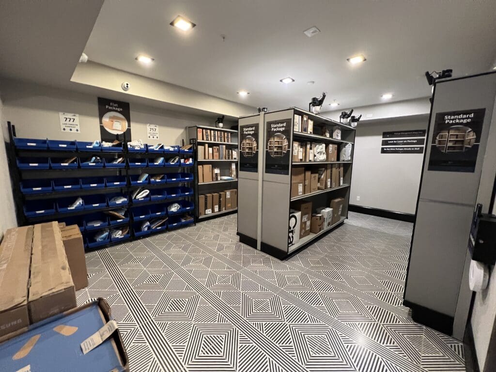 Organized Smart Package Room with labeled shelving zones and open layout, showing how to streamline package delivery in residential buildings with efficient package management systems.