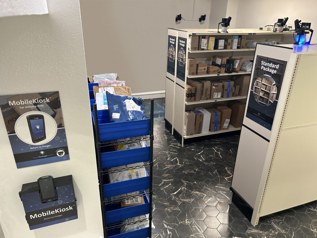 Full interior view of a Smart Package Room system featuring open shelving, organized package areas and Amoeba modules overhead.