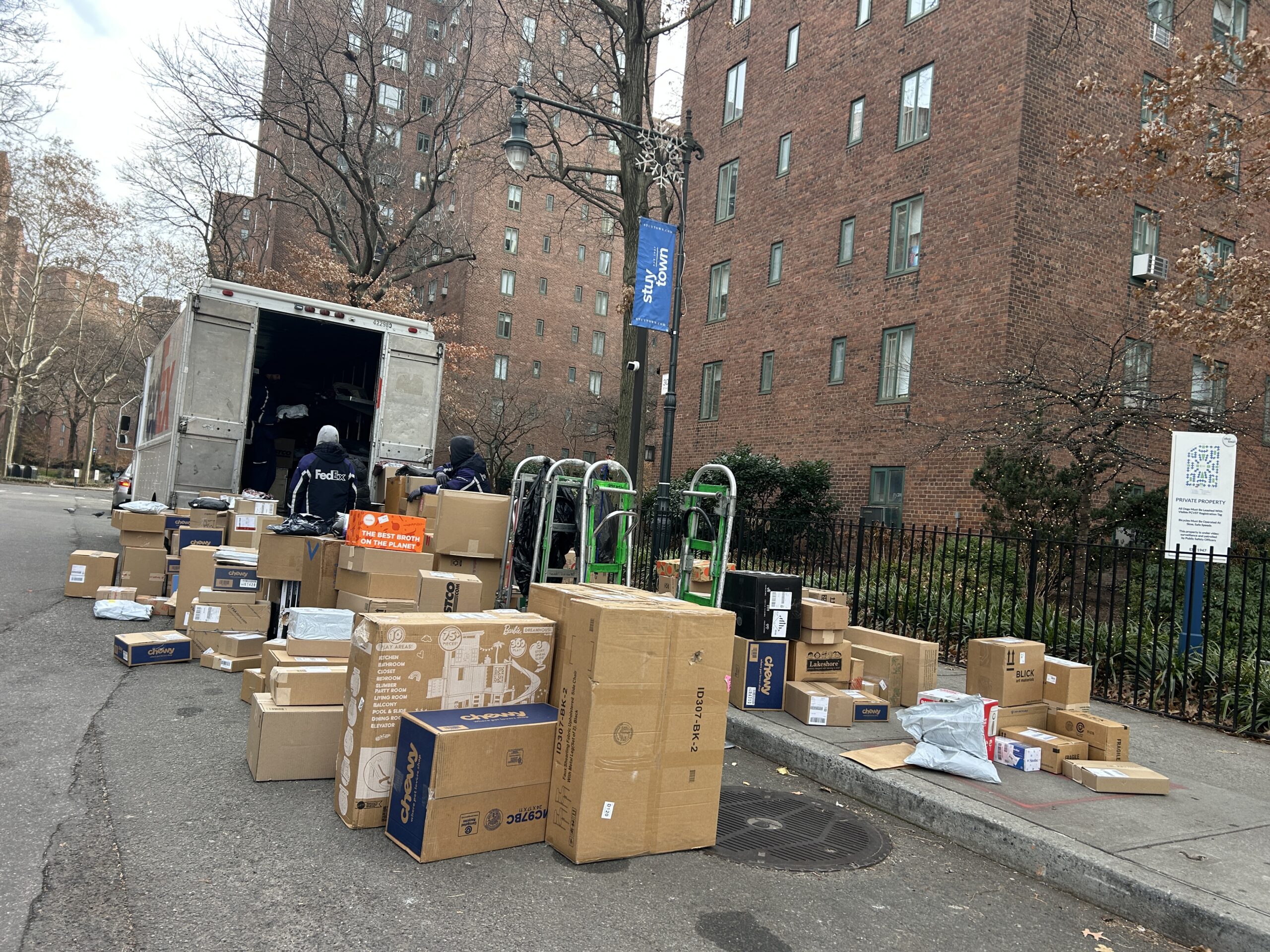 IMG_5127 Packages being unloaded from a delivery truck outside a multifamily property before entering the Smart Package Room system.