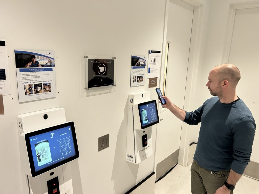 Resident scanning a QR code at a package room kiosk to retrieve a delivery