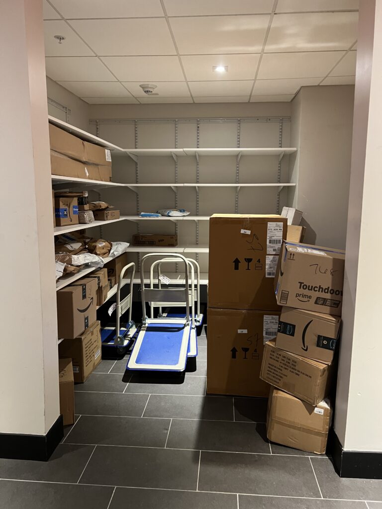 Temporary overflow staging area with oversized packages organized on the floor
