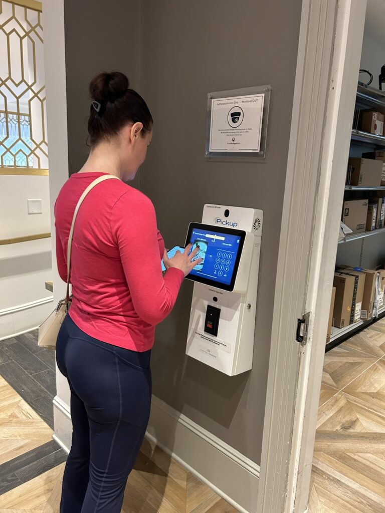 Resident entering a PIN on an external kiosk to retrieve a package from a monitored self-service package room