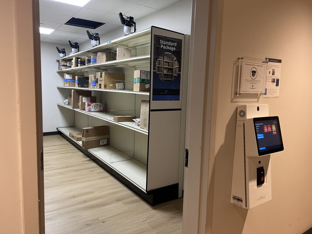 Smart Package Room open-shelving package room entrance with an external wall kiosk and Amoeba sensors mounted overhead