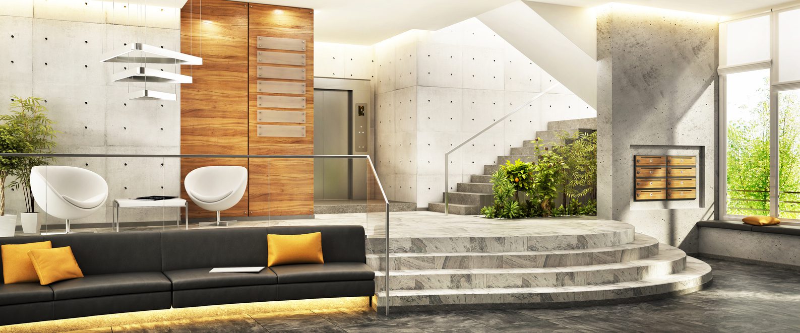 IMG_5127 Modern multifamily apartment lobby with lounge seating, staircase, and a wall of wood resident mailboxes