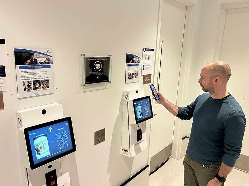 Resident scanning a QR code at a Smart Package Room entry kiosk for self-service package pickup