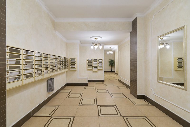 IMG_5127 Narrow apartment lobby lined with mailboxes and no dedicated package room floor area for parcel storage